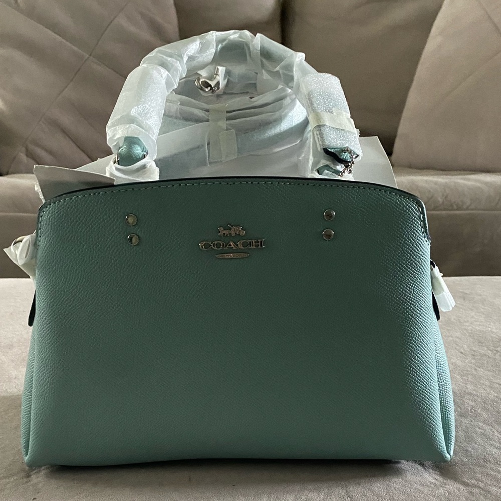 brand new with tags coach hand bag or over the shoulder bag in sea foam color.
